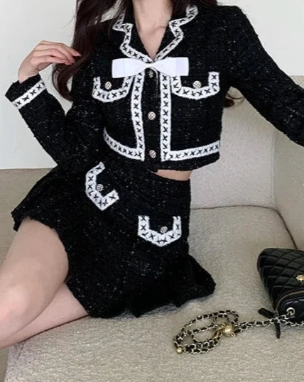 Women's black and white jacket and mini skirt suit